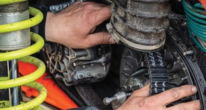 Hands working on an engine